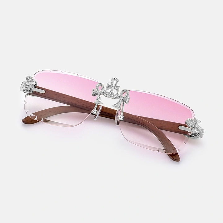 Sunglasses with pink lenses and wooden frame on a white background