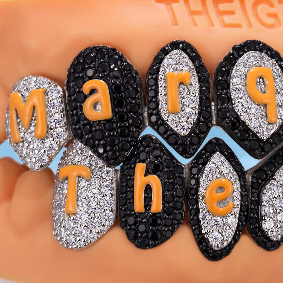 Decorative earrings with rhinestone embellishments spelling out 'Mary The'