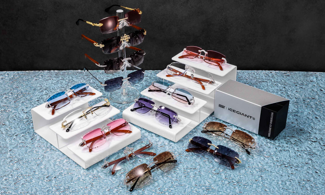 Collection of sunglasses on display stands with a branded box on a textured surface.